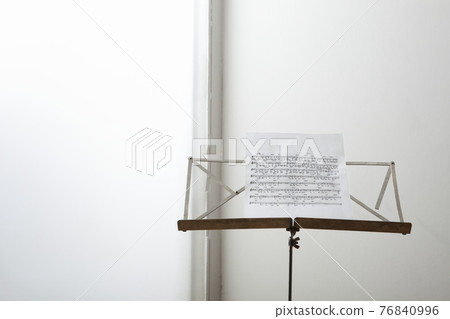 Closeup of a sheet music on music stand 76840996