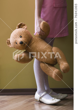 Lowsection Of Girl Holding Teddy Bear 76841003