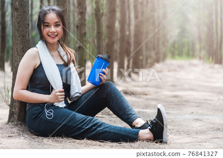 Beautiful sport young woman girl lifestyle exercise healthy break drinking water from bottle after running workout Beautiful sport young woman girl lifestyle exercise healthy break drinking water from bottle after running workout 76841327