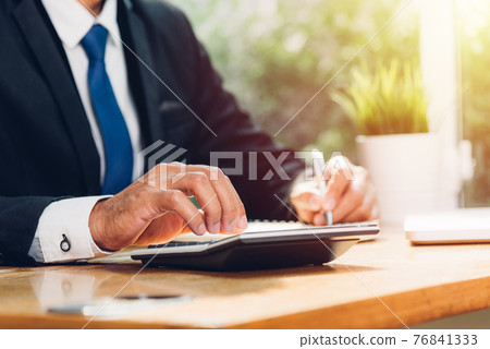 Business man accounting using calculating and work with laptop computer 76841333