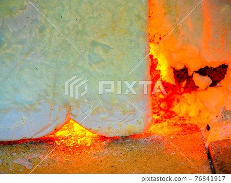 Shining glass blowing furnace behind cover. Gas kiln in glass design studio Shining glass blowing furnace behind cover. Gas kiln in glass design studio 76841917