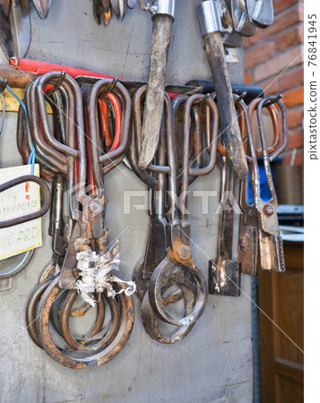 Classic tools and blowing glass diamond Scissors on a Metal rack 76841945