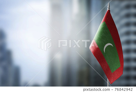 A small flag of Maldives on the background of a blurred background 76842942
