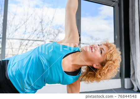 Close up mature sportive exercising woman face Close up mature sportive exercising woman face 76844548