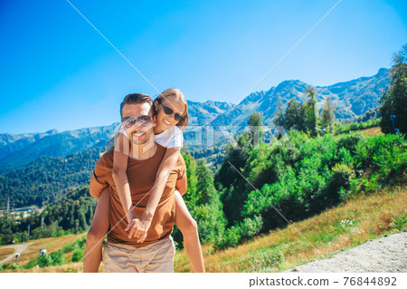Beautiful happy family in mountains in the background of fog 76844892