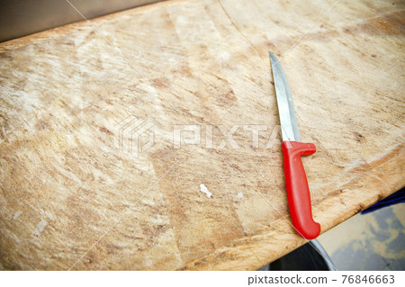 Kitchen knife on wooden cutting board in store Kitchen knife on wooden cutting board in store 76846663