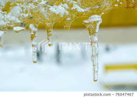 Melting hanging icicles and water drops, winter view Melting hanging icicles and water drops, winter view 76847467