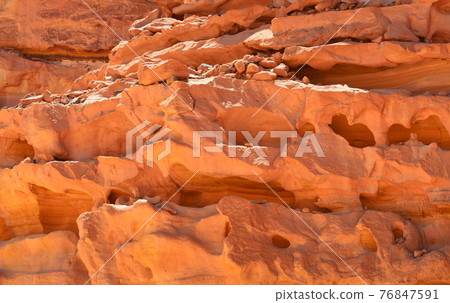 Rocks of multicolored sandstone in a colored canyon in the southeast of the Sinai Peninsula Rocks of multicolored sandstone in a colored canyon in the southeast of the Sinai Peninsula 76847591