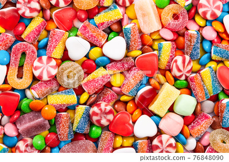 Colorful chocolate dragee and different candy. 76848090