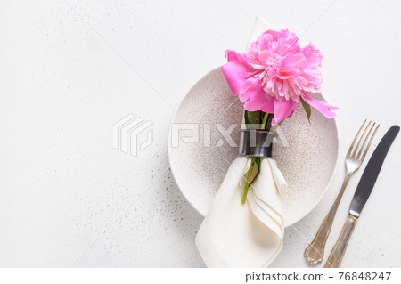Festive table setting with a peony flowers. Festive table setting with a peony flowers. 76848247
