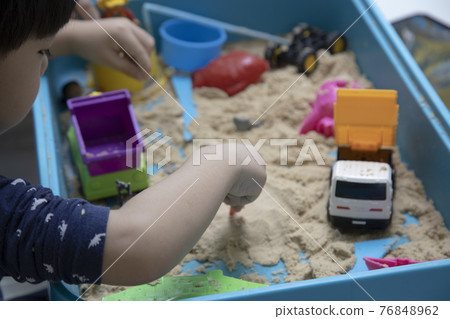 Children playing in the sand Children playing in the sand 76848962