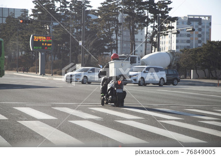 Motorcycle stopped at intersection Motorcycle stopped at intersection 76849005
