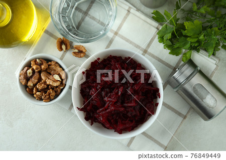 Concept of tasty eating with bowl of beet salad on white textured table Concept of tasty eating with bowl of beet salad on white textured table 76849449