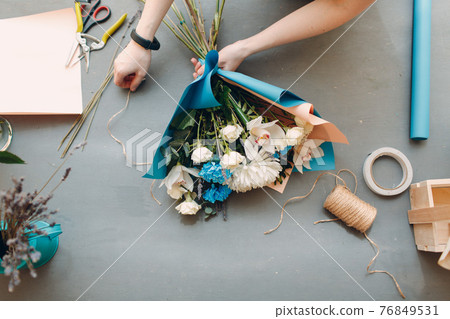 Florist woman making bouquet in flower boutique Florist woman making bouquet in flower boutique 76849531