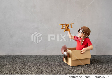 Happy child dreaming about travel Happy child dreaming about travel 76850726