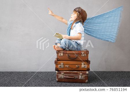 Happy child dreaming about summer vacation and travel 76851194