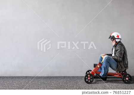 Senior businessman against concrete wall with copy space Senior businessman against concrete wall with copy space 76851227