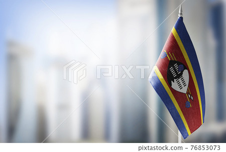 A small flag of Swaziland on the background of a blurred background A small flag of Swaziland on the background of a blurred background 76853073
