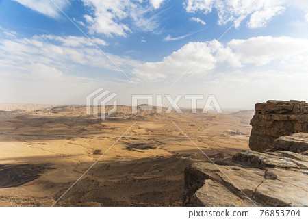 Ramon Crater Makhtesh Ramon, the largest in the world, as seen from the high rocky cliff edge surrounding it from the north, Ramon Nature reserve, Mitzpe Ramon, Negev desert, Israel Ramon Crater Makhtesh Ramon, the largest in the world, as seen from the high rocky cliff edge surrounding it from the north, Ramon Nature reserve, Mitzpe Ramon, Negev desert, Israel 76853704
