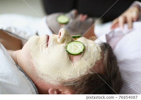 Man and woman applied clay rejuvenating mask to their faces 76854087