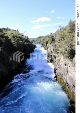 Fukafall, a blue river bubbling white with a huge stream of water [Taupo, New Zealand] 76854938