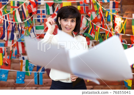 Happy woman throws paperwork into the air 76855041