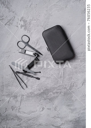 Set of manicure, pedicure tools and accessories with case, stone concrete background, top view Set of manicure, pedicure tools and accessories with case, stone concrete background, top view 76856235