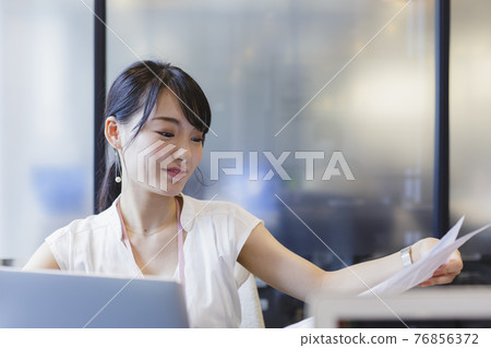 Female business scene working at a desk 76856372