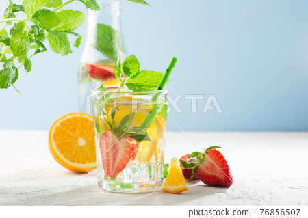 Summer detox beverage concept. Citrus fruit drinks with ice. Healthy diet cocktail with fresh berries and mint 76856507