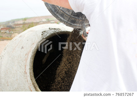 Laborer working with concrete Laborer working with concrete 76857267