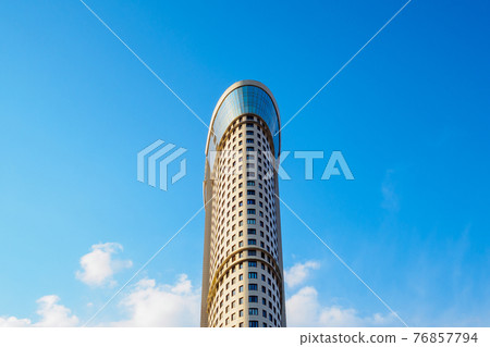 Unknown high stately building against the blue sky. Unknown high stately building against the blue sky. 76857794