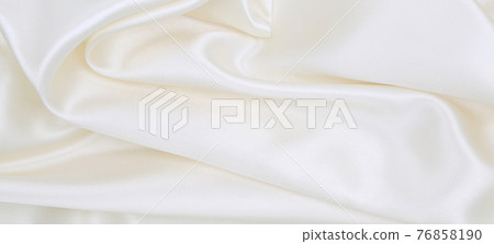 Smooth elegant white silk or satin luxury cloth texture as wedding background. Luxurious background design 76858190