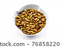 Almonds inside a porcelain bowl. Perfect shot for breakfast, vegan living and wellness. 76858220