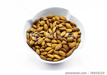Almonds inside a porcelain bowl. Perfect shot for breakfast, vegan living and wellness. Almonds inside a porcelain bowl. Perfect shot for breakfast, vegan living and wellness. 76858220