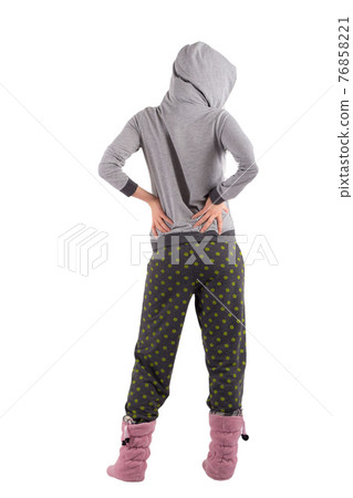 girl in pajamas gray top with a hood, pants with green circles and ugg boots on her legs. white background girl in pajamas gray top with a hood, pants with green circles and ugg boots on her legs. white background 76858221