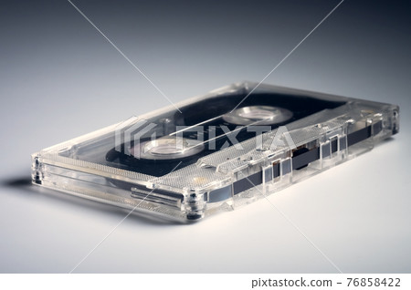 Audio cassettes on gray background retro background. Old sound recorders Audio cassettes on gray background retro background. Old sound recorders 76858422