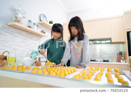 two little girl making nastar tart cake together two little girl making nastar tart cake together 76858520