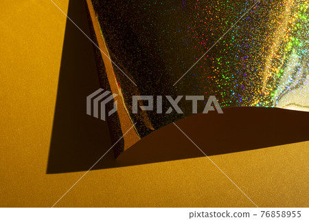 Composition with gold holographic paper. Retro futuristic style. Composition with gold holographic paper. Retro futuristic style. 76858955