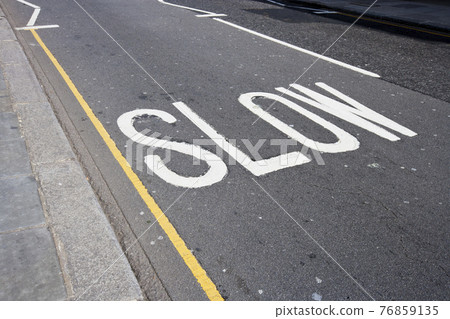 Close-Up of road marking saying Slow in London, UK Close-Up of road marking saying Slow in London, UK 76859135