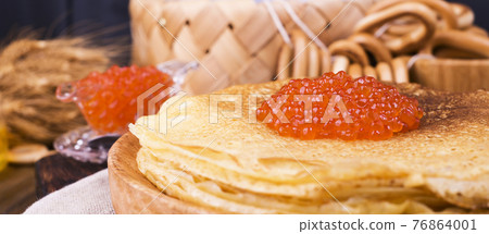 Shrovetide Maslenitsa Week festival meal. Stack of russian pancakes with red caviar. Rustic style Shrovetide Maslenitsa Week festival meal. Stack of russian pancakes with red caviar. Rustic style 76864001