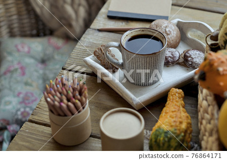 Autumn, pumpkins, hot steaming cup of coffee on a wooden table background. Seasonal, morning coffee 76864171