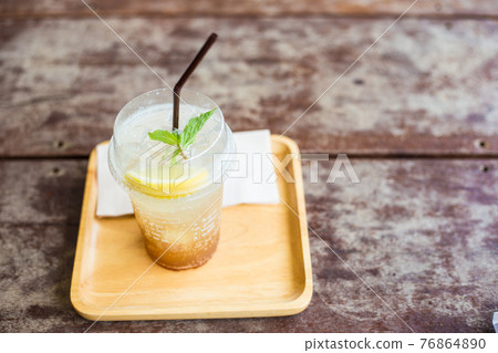 Lemon lime ice drink in plastic bottle on wood table 76864890