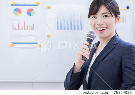 Business woman presenting with a microphone 76864928