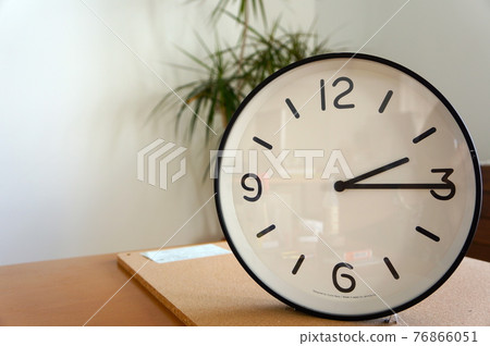 A simple clock that points to 2:15 76866051
