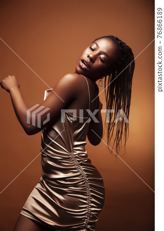 pretty young african american woman with braids posing cheerful gesturing on brown background, lifestyle people concept pretty young african american woman with braids posing cheerful gesturing on brown background, lifestyle people concept 76866189