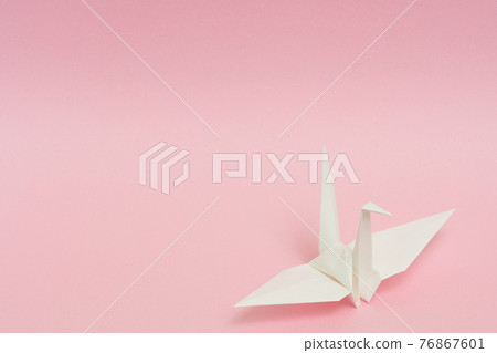 White paper cranes on a pink background 76867601