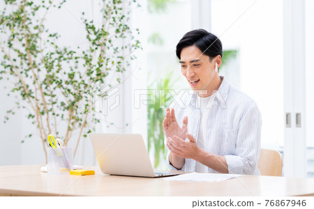 Middle-aged man having a web conference on telework Middle-aged man having a web conference on telework 76867946