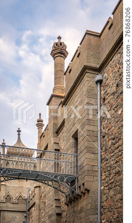 The walls and towers of the old palace on the background of a cloudy sky The walls and towers of the old palace on the background of a cloudy sky 76868206