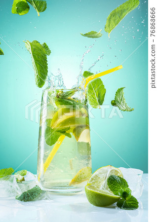 Mojito with mint and ice. Flying spray and mint. A vivid photograph of a refreshing drink. 76868666
