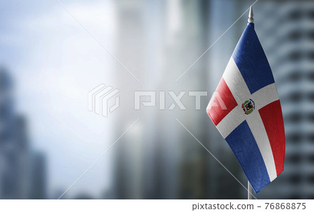 A small flag of Dominicana on the background of a blurred background A small flag of Dominicana on the background of a blurred background 76868875